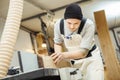 Worker processes board on woodworking machine Royalty Free Stock Photo