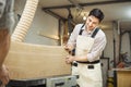 Worker processes board on woodworking machine Royalty Free Stock Photo
