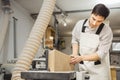 Worker processes board on woodworking machine Royalty Free Stock Photo