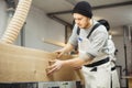 Worker processes board on woodworking machine