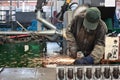 Worker processing metal, lots of sparks, against factory industrial interior background