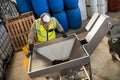 Worker processing olives in machine