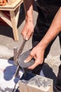 Worker produces roofing slate using a slate hammer.