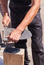 Worker produces roofing slate using a slate hammer. Royalty Free Stock Photo