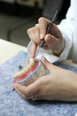 Worker producing fake teeth