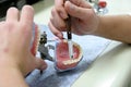 Worker producing fake teeth