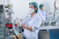 Worker producing surgical mask in modern factory, Covid-19 protection and medical concept