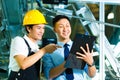 Worker and production manager with Clipboard