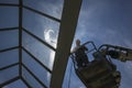 Worker of Professional Facade Cleaning Services washing a glass