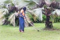 Worker with protective clothing cutting grass with grass cutter