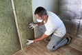 Worker in protective goggles and respirator insulating rock wool insulation in wooden frame for future house walls for cold Royalty Free Stock Photo