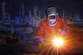 Worker with protective mask welding metal and sparks