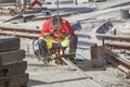 Worker with protective mask welding tram tracks