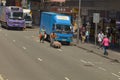 11 May 2013 worker pulling heavily loaded trolley or barrow on traffic street