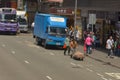 11 May 2013 worker pulling heavily loaded trolley or barrow on traffic street