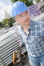 Worker pulling pallet tubing Royalty Free Stock Photo