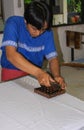 Worker pushes Batik wax stamp in Winotosastro factory in Yogyakarta, Java, Indonesia