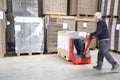 Worker Pushing Stock On Handtruck