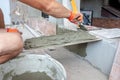 worker pushing the tile into the cement. renovation concept