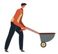 Worker pushing wheelbarrow at construction site