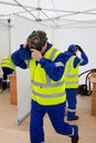 Worker puts on gas mask to protect against gas in emergency