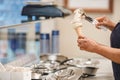 Worker puts Italian ice cream cone in horn with chocolate Royalty Free Stock Photo