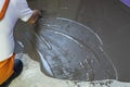 Worker puts a self leveling screed