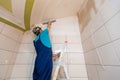 Worker are putting up the wall from ladder in apartment is under construction, remodeling, renovation, overhaul Royalty Free Stock Photo