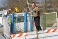 Worker with rake tiding up leaves on lorry