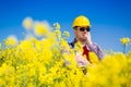 Worker in a rapeseed field doing inspection for biodiesel production Royalty Free Stock Photo