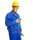 Worker reading message in his mobile phone