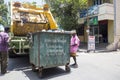 Worker of recycling garbage collector truck loading waste and trash bin