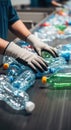 Worker recycling plastic bottles. Man hand sorting garbage on conveyor belt. Waste processing, environmental sustainability Royalty Free Stock Photo