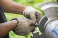 The worker regrinding the lathe tool with dressing wheel Royalty Free Stock Photo