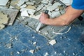 Worker remove, demolish old tiles in a bathroom with hammer and chisel Royalty Free Stock Photo