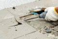 Worker remove, demolish old tiles a bathroom with jackhammer,