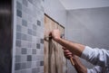 Worker remove demolish old tiles in a bathroom