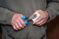 Worker remove a nail from wooden workpiece