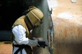 Worker is remove paint by air pressure sand blasting Royalty Free Stock Photo