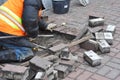 Worker remove and repair concrete paving blocks. Royalty Free Stock Photo