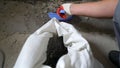 Builder cleaning room from old concrete and bricks after demolition jobs. A worker removes garbage with a dustpan Royalty Free Stock Photo