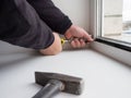 Worker removes the lock insulating glass of a plastic window