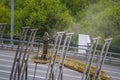 A worker removes old paint from road barriers