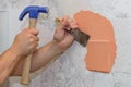 Worker removes old paint with a spatula