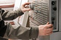 Worker removes the part from CNC lathe machine. Turning machine for drilling with the drill tool and center drill tool .The hi- Royalty Free Stock Photo