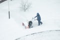 Worker removes snow with a machine, cleans the street Royalty Free Stock Photo