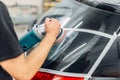 Worker removes the track from wiper blade on car