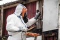 team in protective gear removing asbestos in a house