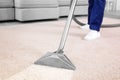 Worker removing dirt from carpet, closeup. Cleaning service Royalty Free Stock Photo