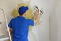 Worker removing old painted wallpaper from the wall. house renovation interior renewal Royalty Free Stock Photo